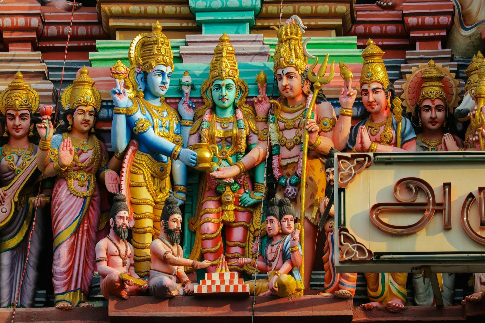 Detailed Hindu god sculptures adorn a temple in Chennai, showcasing rich cultural and religious artistry.