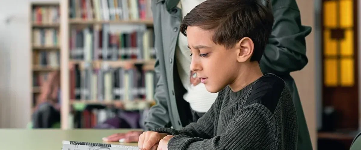 Teacher evaluating student reading benchmarks — reading level systems compared chart