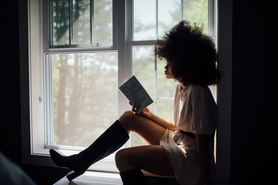 A reader at a sunlit window working through a contemporary novel — the reader profile that finishes Ugly Love in two evenings