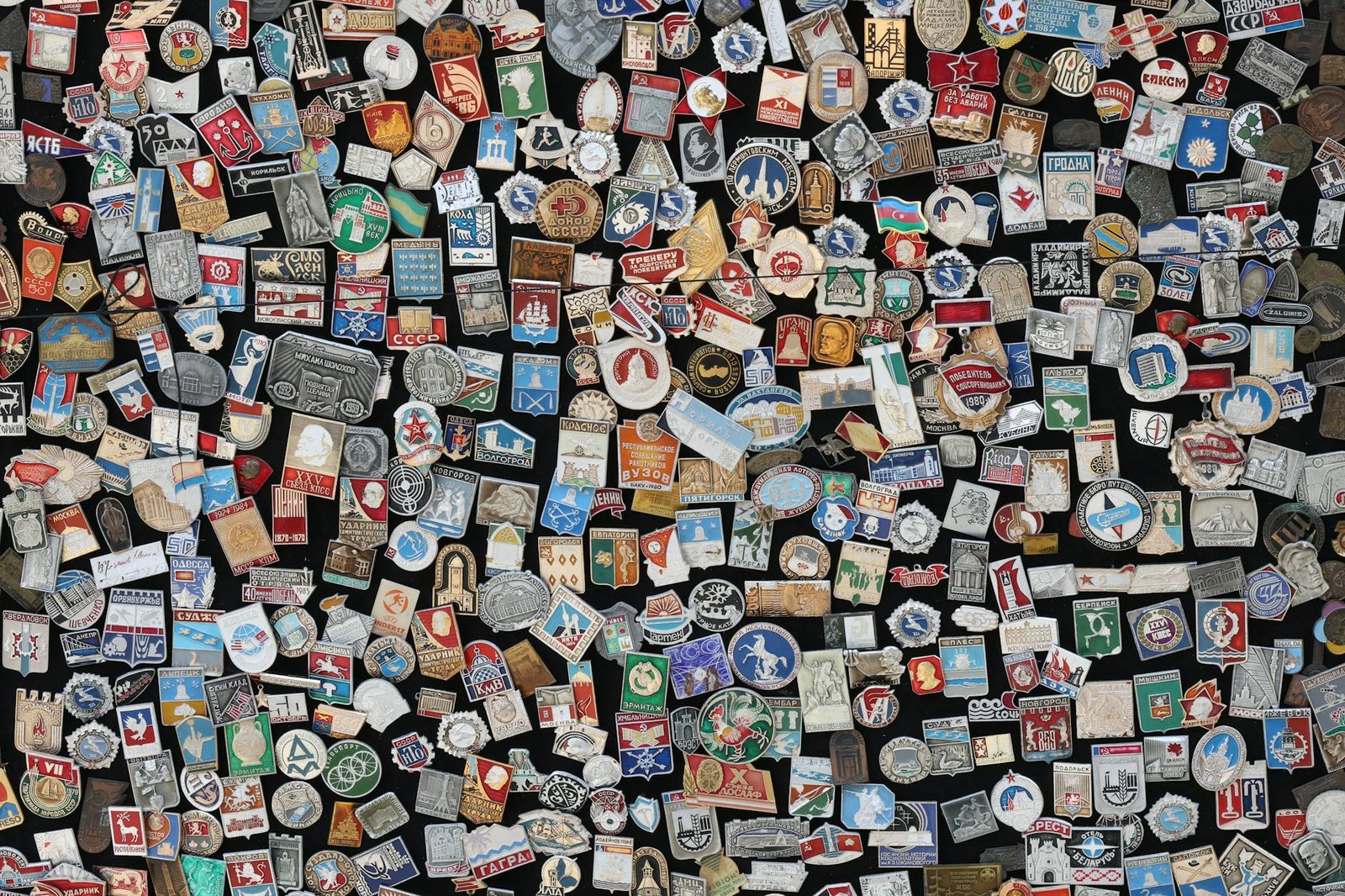 Colorful array of vintage Soviet-era badges and pins on display, showcasing diverse designs and symbols.